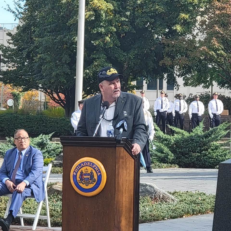 Pat speaking with war memorial 2.jpg